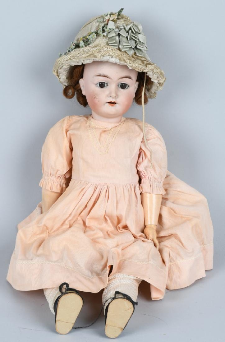GERMAN KARL HARTMANN BISQUE DOLL: nice bisque doll head with jointed composition body. Brown eyes, open mouth with 4 teeth. Hat has Albert Steiger label. No hairlines chips or cracks. there is a light rub on the nose. Displays well. 2