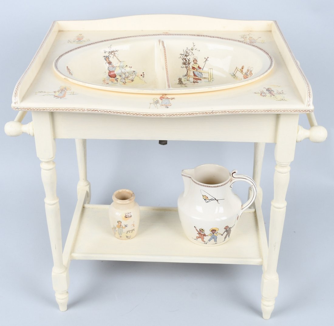 FRENCH KATE GREENAWAY CHILD's WASH STAND: French Sarreguemines wood framed stand with ceramic top. Measures 19" by 21" by 19". Some chipping underneath to top where it clamps to frame. complete with sink, ewer and small jar. The sink has a ha