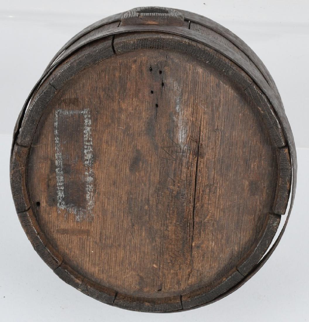 EARLY 19TH CENTURY AMERICAN WOOD PANEL CANTEEN: Early 19th century American wood paneled canteen with iron bands and rivets. Measures 7.5 inches across x 4.625". Larger sized canteen typically used on a horse/mule drawn wagon. Sides are warped. Ini
