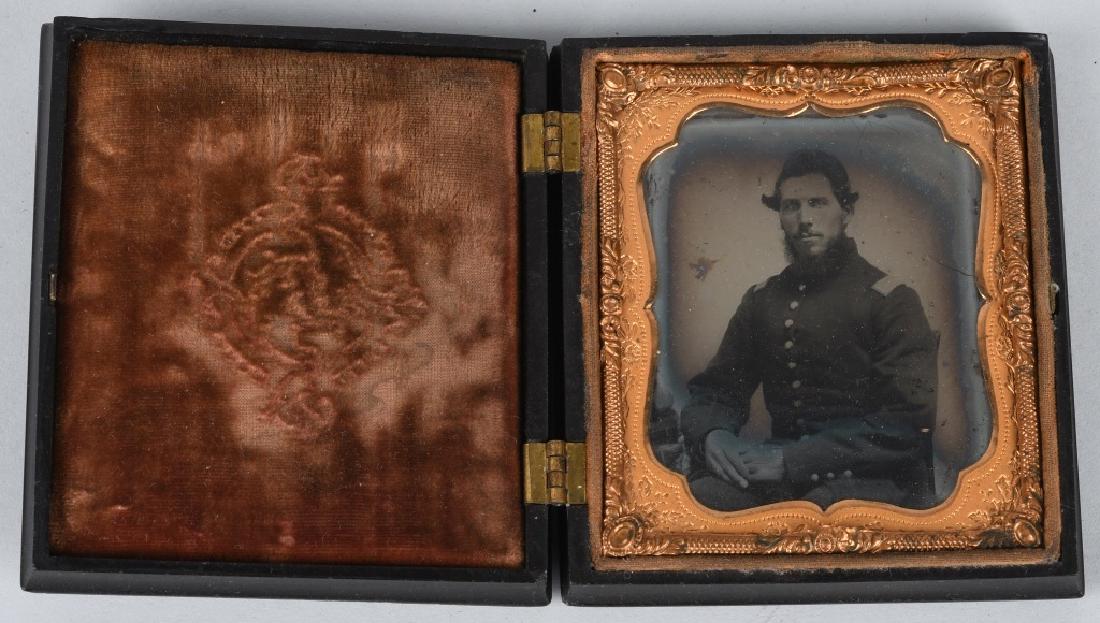 CIVIL WAR AMBROTYPE - PATRIOTIC THERMOPLASTIC CASE: 1/6th plate ambrotype of a seated Union officer. Image is housed in a patriotic " Constitution and the laws " thermoplastic case. Back cover is a floral motif. Very good.