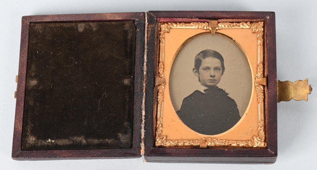 CIVIL WAR MATTHEW BRADY TWO SIDED VIEW AMBROTYPE: 1/9th plate ambrotype of a boy housed in a case in which the mat and photograph are in a hinged center piece that allows the image to be looked at on each side; giving a reverse view of the subject. I