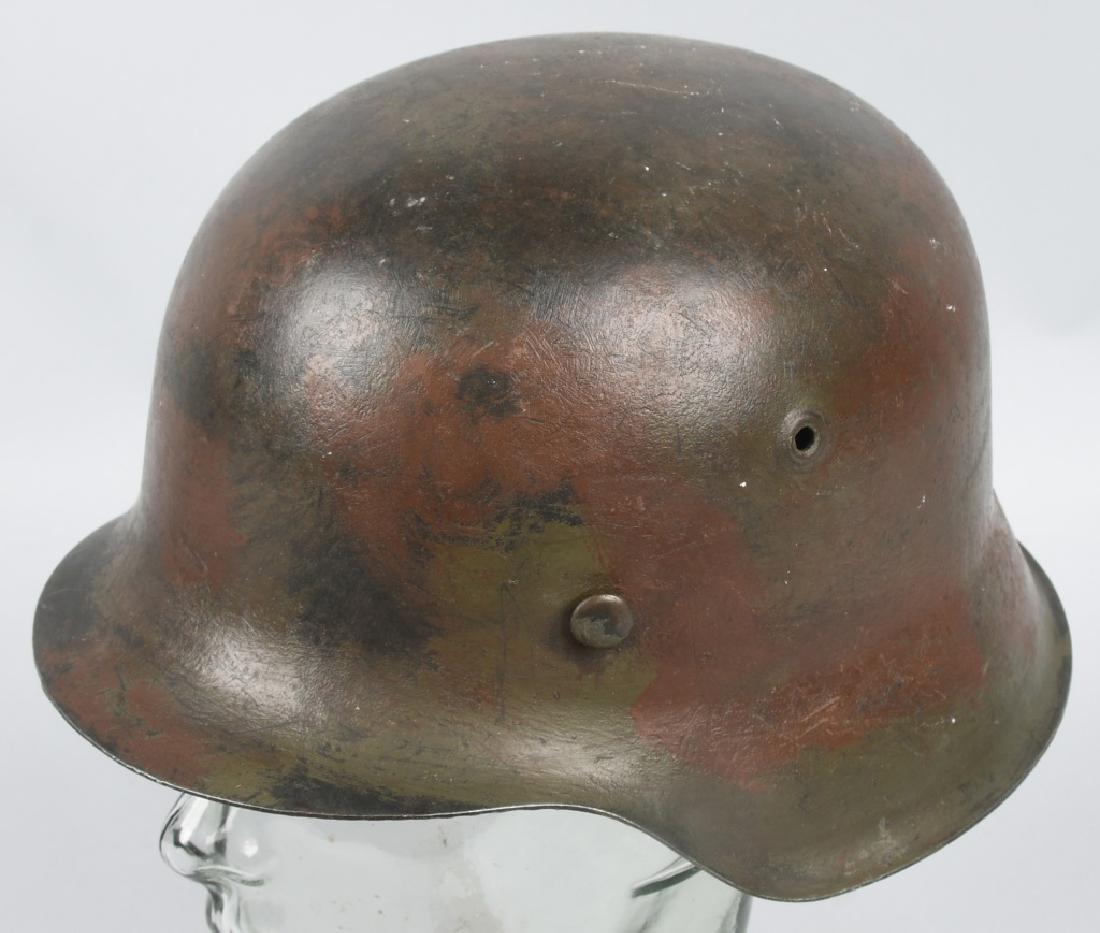 GERMAN WW2 M42 CKL64 NORMANDY CAMO HEER HELMET: This is a beautiful brush stroke camouflage helmet typical of the Normandy pattern with a tan base coat of paint followed by spray or brush strokes in dark forest green and reddish brown hues. The ove