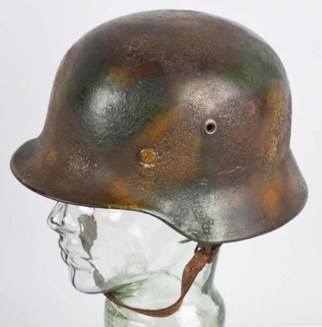 WWII NAZI GERMAN M 40 NORMANDY PATTERN CAMO HELMET: M40 helmet with Normandy pattern camouflage. A tank paint was used to apply the camo giving it a more textured look. Helmet & liner are complete. Rear of rim stamped Q64 with lot number DN358. The "Q"