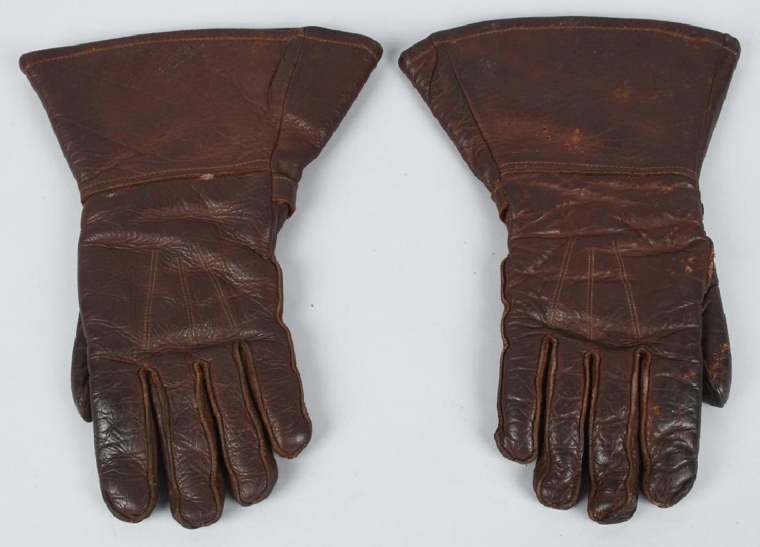 WWII BRITISH LEATHER FLYING GLOVES: World War Two British 5 finger leather gauntlets with functioning snaps marked Newey Pat. 201430-22. Wool lined. very good - excellent.
