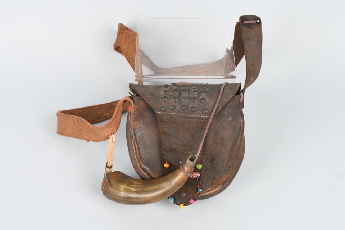 ANTIQUE LEATHER HUNTERS POUCH & POWDER HORN: Leather pouch has flap adorned with brass tacks and glass beads. The strap is heavy cloth and leather. Included in the pouch are a bullet mold, cap tin, bone handle fork and more. The powder horn is a