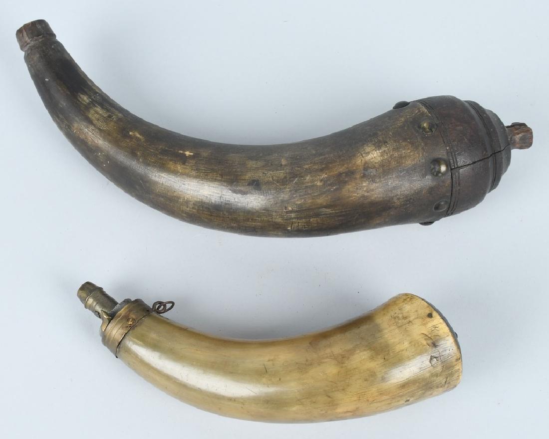 2-19th CENT. CARVED GUNPOWDER HORNS: Largest horn has a carved spout, and large carved wood plug that is attached by brass tacks. It measures about 13". The smaller horn has a brass powder flask spout with working spring. It measures abo