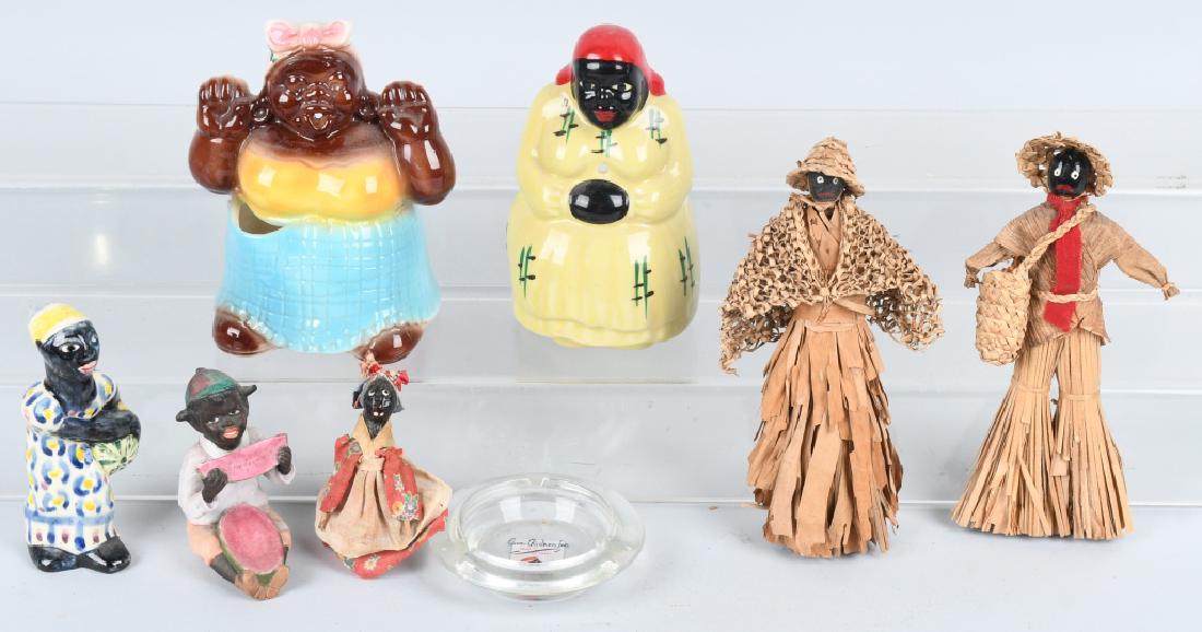 BLACK AMERICANA GROUPING, DOLLS and MORE: Lot includes 2 - 8" corn husk dolls, a a glazed pottery figure with watermelon, a bisque seated figure eating watermelon, a McCoy string holder, an unmarked ceramic string holder and more. Condition v