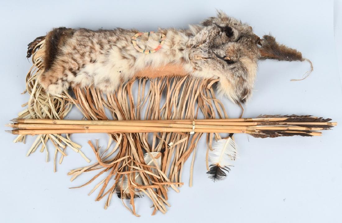 LEATHER & FUR DECORATED QUIVER and ARROWS: Well made with Bobcat pelt. Includes 6 flint pointed arrows. Quiver is 21", arrows are 30". Excellent