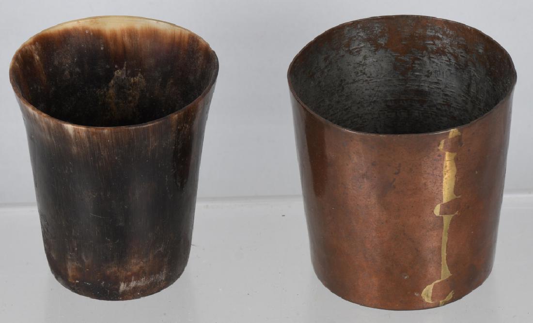 2-EARLY DRINKING CUPS, COPPER & HORN: The copper cup is measures 2" by 2", and has dove tail construction. The other cup appears to be made of horn and measures 2" by 1 3/4". Very Good