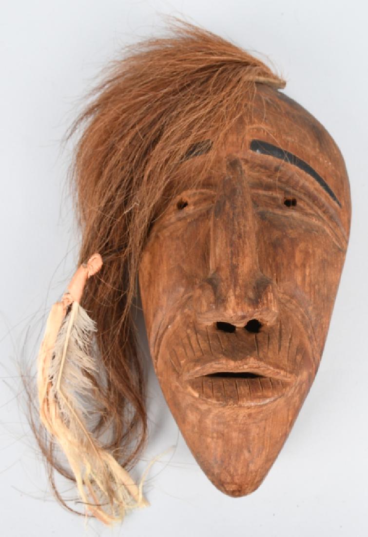 VINTAGE IROQUOIS INDIAN FALSE FACE MASK: Iroquois Indian False Face Mask. Well hand carved wood. Has horse hair with feather decoration. 11 1/2" Excellent