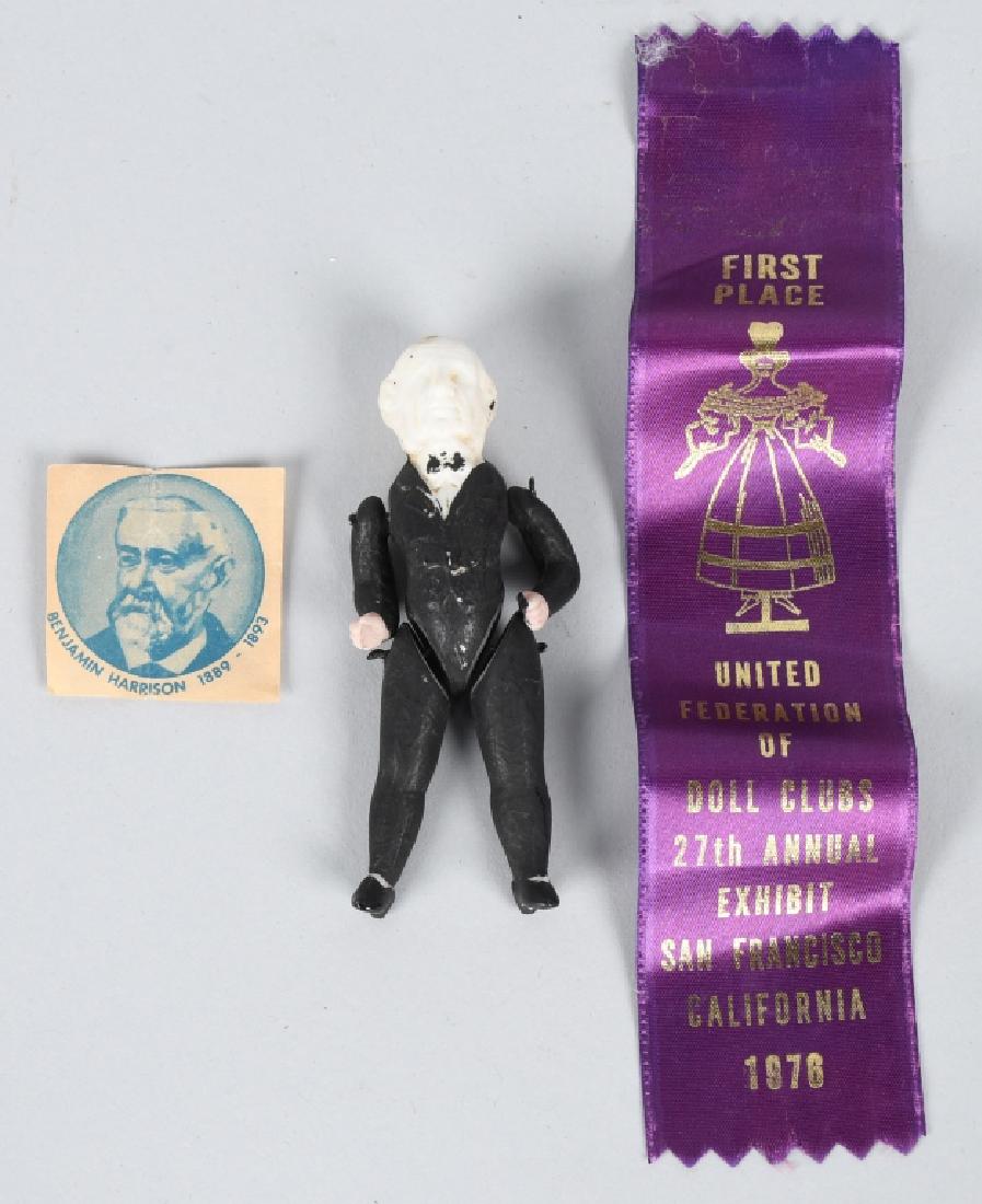 PRESIDENT BENJAMIN HARRISON BISQUE DOLL: Fully jointed bisque doll in the form of Benjamin Harrison, 23rd President (1889–1893). Most likely a campaign souvenir for children. Includes a 1976 Doll club First Place ribbon. 3 1/2", Very Good