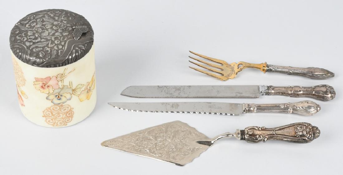 4-SILVER HANDLED SERVING UTENSILS & MORE: Lot includes 2 carvings knives, a cake knife and serving fork. The carvings have handles marked sterling. Also included is a ornate vanity jar with metal top. Measures 5" high and 4" diameter. Very Go