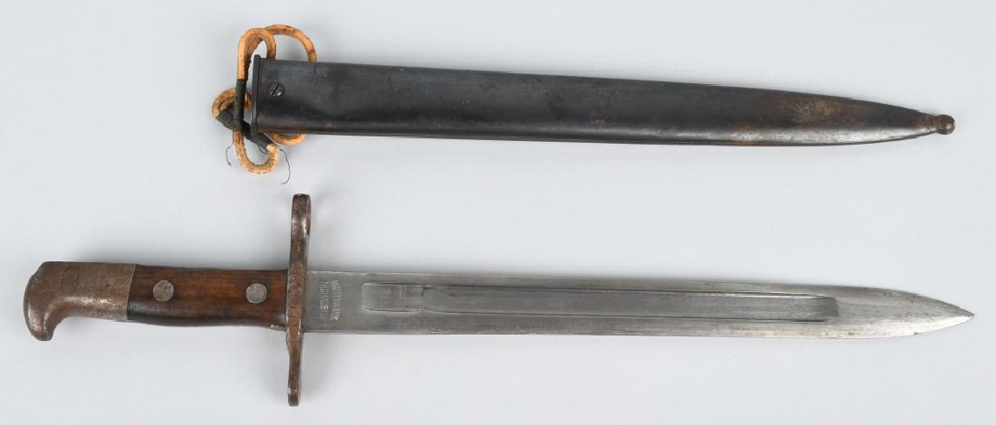 WWI SWISS BAYONET WAFFENFABRIK NEUHAUSEN: Vintage Swiss Army bayonet Schmidt Rubin Scabbard. Waffenfabrik Neuhausen. Blade measures approx 11 7/8 inches. Unsheathed Bayonet measures approx 16 1/2 inches long, and 17 1/4 with sheath. Serial#: 