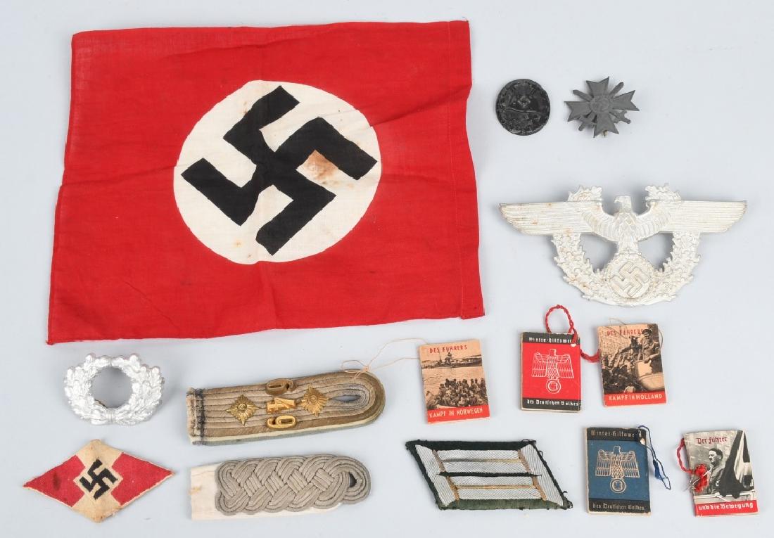 WWII NAZI GERMAN FLAG MEDAL AND INSIGNIA LOT: lot including a small 11" x 9" party flag, shoulder straps, wound badge stamped 93 and missing pin, shako plate, merit cross with swords, HK insignia and 5 matchbook-size booklets. very good.
