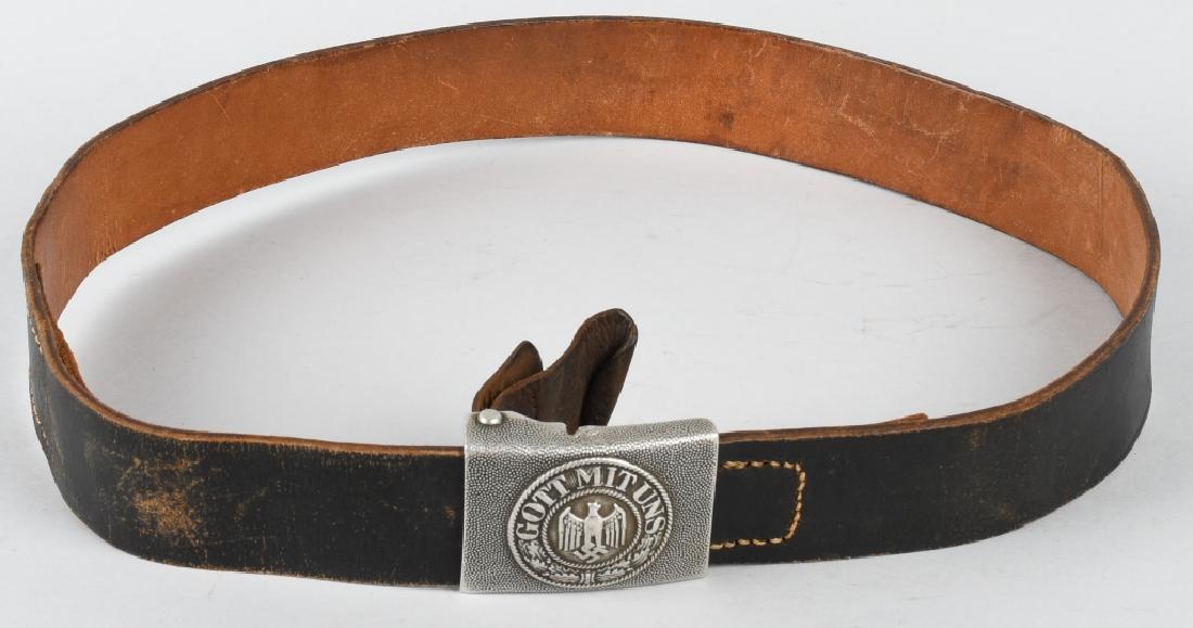 WWII NAZI GERMAN ARMY BELT AND BUCKLE: Belt and buckle featuring a pebbled aluminum infantry buckle. Leather buckle tab is dated 1938 and manufacturer stamped Schauerte & Hohfeld Lüdenscheid. Underside of belt stamped 85. Leather is in ex