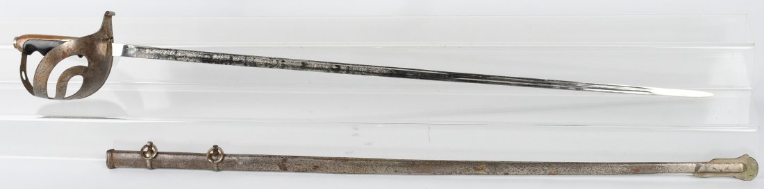 MODEL 1873 ITALIAN ARMY CAVALRY OFFICER\'S SWORD: Model 1873 Italian cavalry sword with etched blade and scabbard. Hilt is iron and grip appears to be applewood. The sword is nickel plated and there is some wear on hilt and scabbard. 32\" blade is br