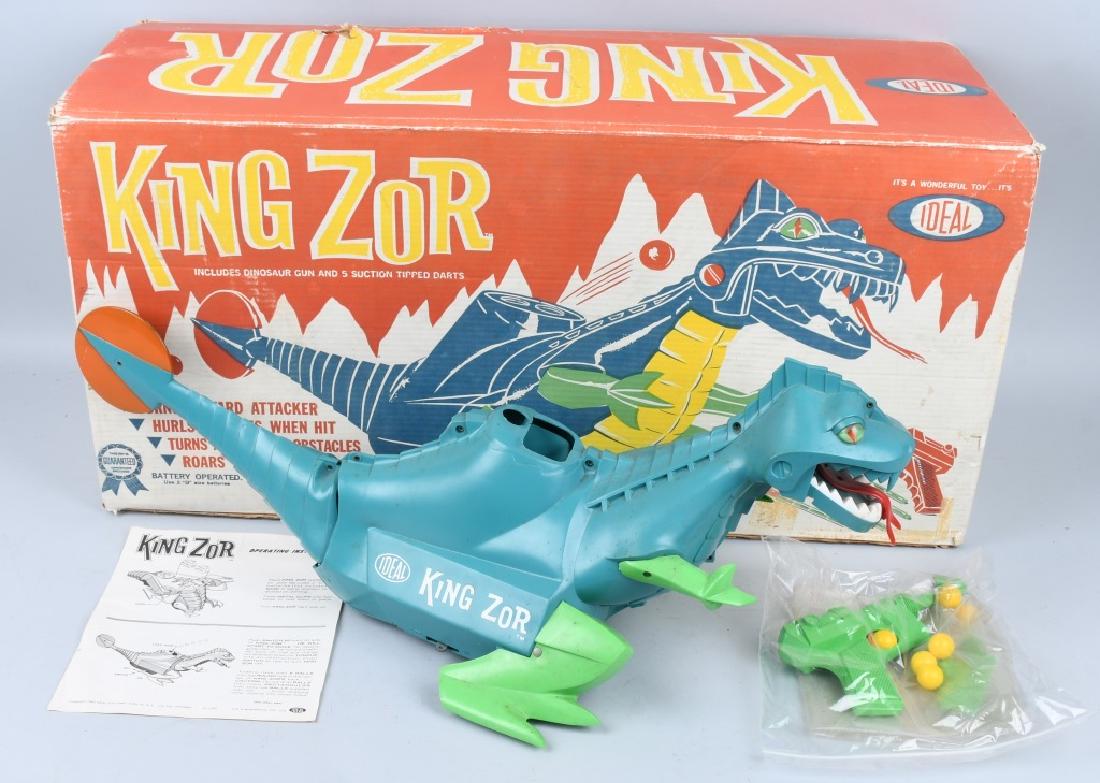 IDEAL 1962 KING ZOR, BOXED: Large battery operated toy measuring 30" long. Includes dart gun (missing darts) and balls. One foot is broken but the piece is included. untested. Includes colorful original box. Very Good-Excellent