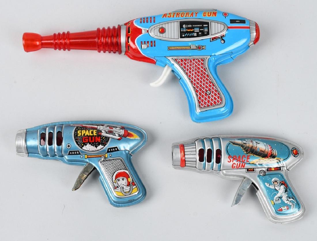 3-VINTAGE TIN SPACE RAY GUNS: The two smaller guns are 5" and have great space graphics and are made in Japan. The largest gun is 9 1/2" and is made in Korea. All three work with noise and sparking action. Provenance: Past collect