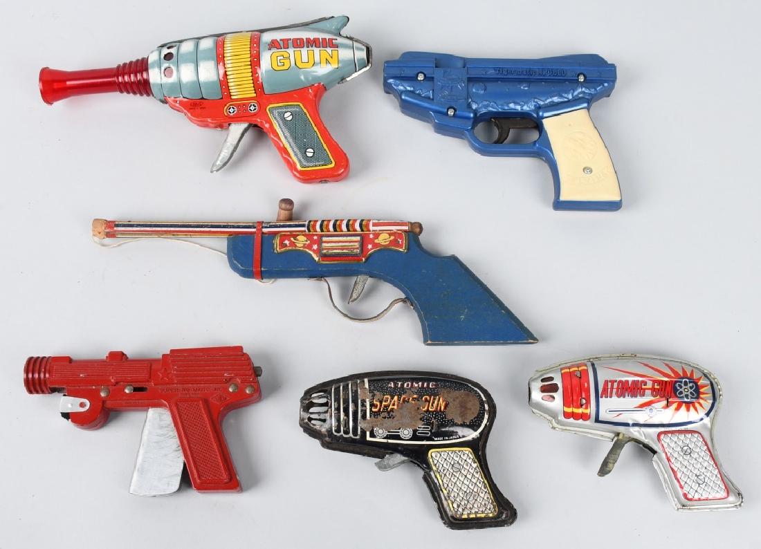 VINTAGE TOY SPACE GUNS & MORE: Lot includes 9" Japan tin Atomic gun, 5" Japan tin Atomic gun, a 6" plastic Apollo Flying Saucer gun and more. All worked when tested. condition varies. Good-Excellent
