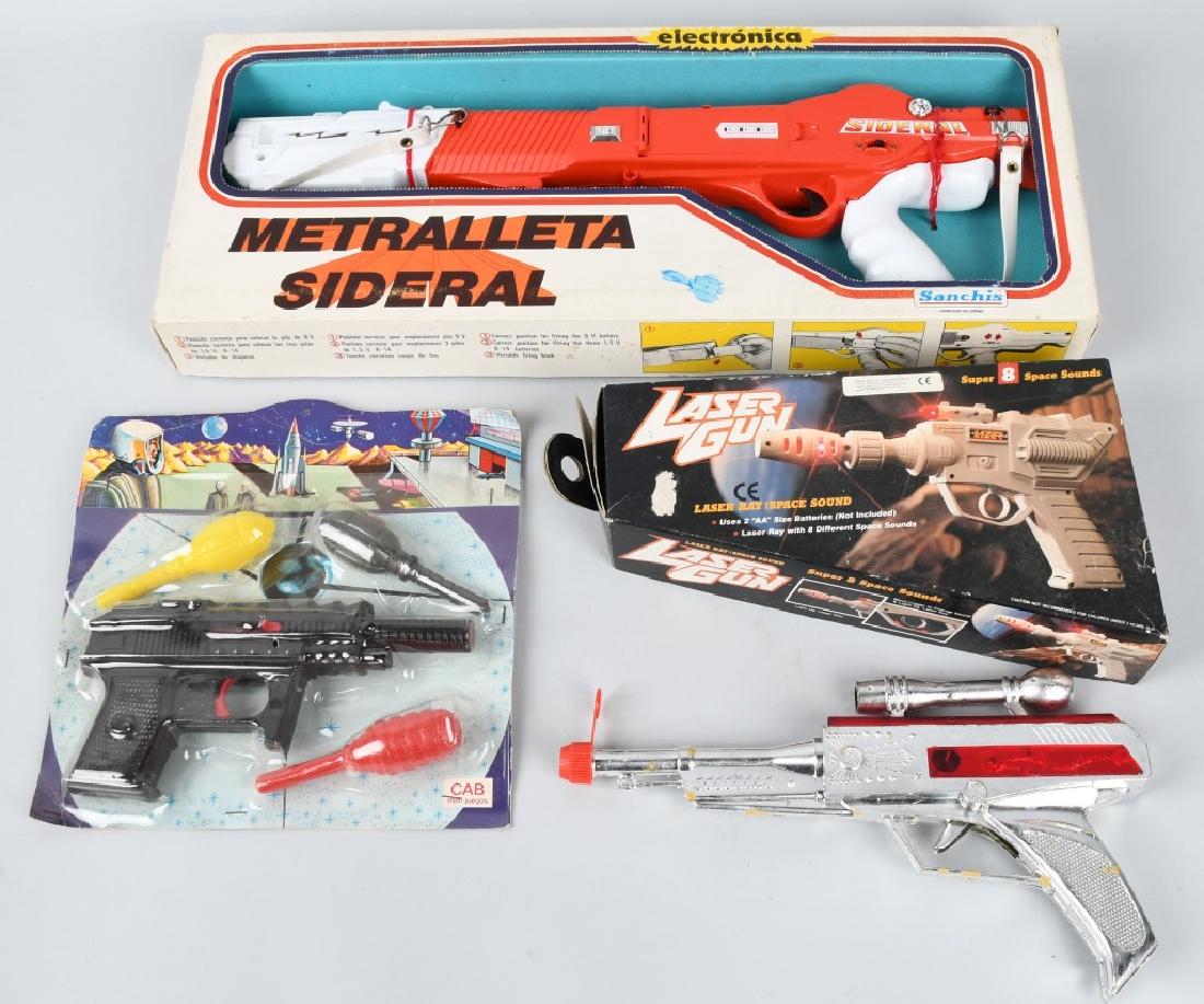 VINTAGE SPACE GUNS: Lot includes vintage Cab mini juegos 8" plastic Space Gun and grenades on card, an 18" Sanchis Spain Metrelleta Sideral in box , A 9" Laser Gun made in China in the original colorful box, along with a