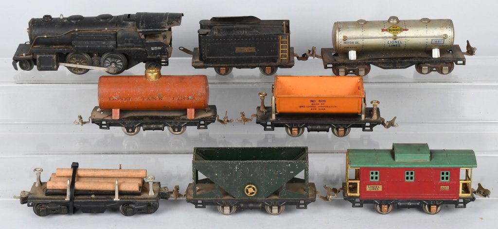 b112LIONEL #258 ENGINE & 6 FREIGHT CARS: Set includes Lionel #258 Engine with Tender, #1680 Sunoco Tank Car, #809 Dumping Oar Car, #804 Tank Car, #3651 Automatic Lumber Car, #803 Oar Car, #807 Caboose. As found condition. May clean to higher