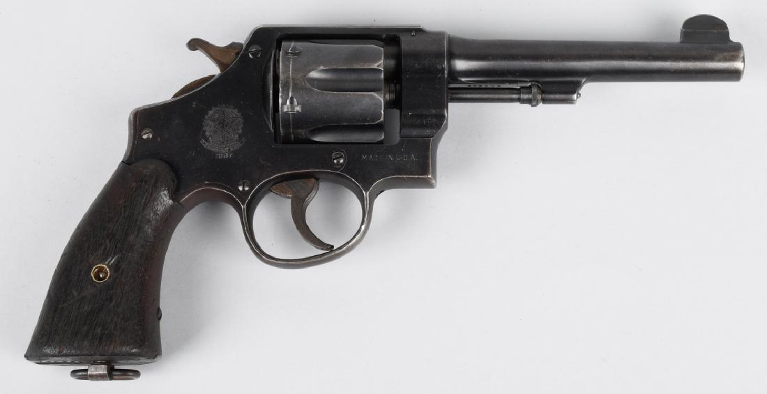 SMITH & WESSON MODEL 1917, .45 REVOLVER: SN 208261, Smith & Wesson Model 1917 Brazilian Contract, MFG 1946. 5 1/2" barrel with good bore 60% blue finish some turning plum brown. Nice markings and good wood grips. Both single and double actio
