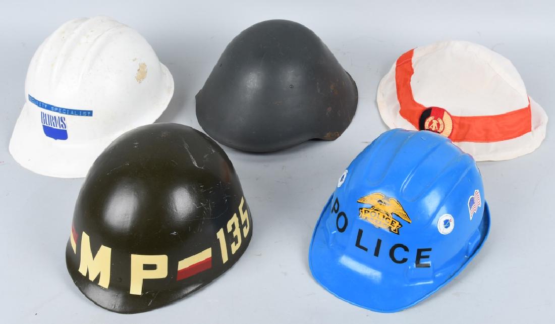 4-MP and LAW ENFORCEMENT HELMETS: Lot includes nice Vietnam era Ohio 135th National Guard MP helmet, a East German helmet with MP cover, and 2 Police and Security hard hats. Very Good