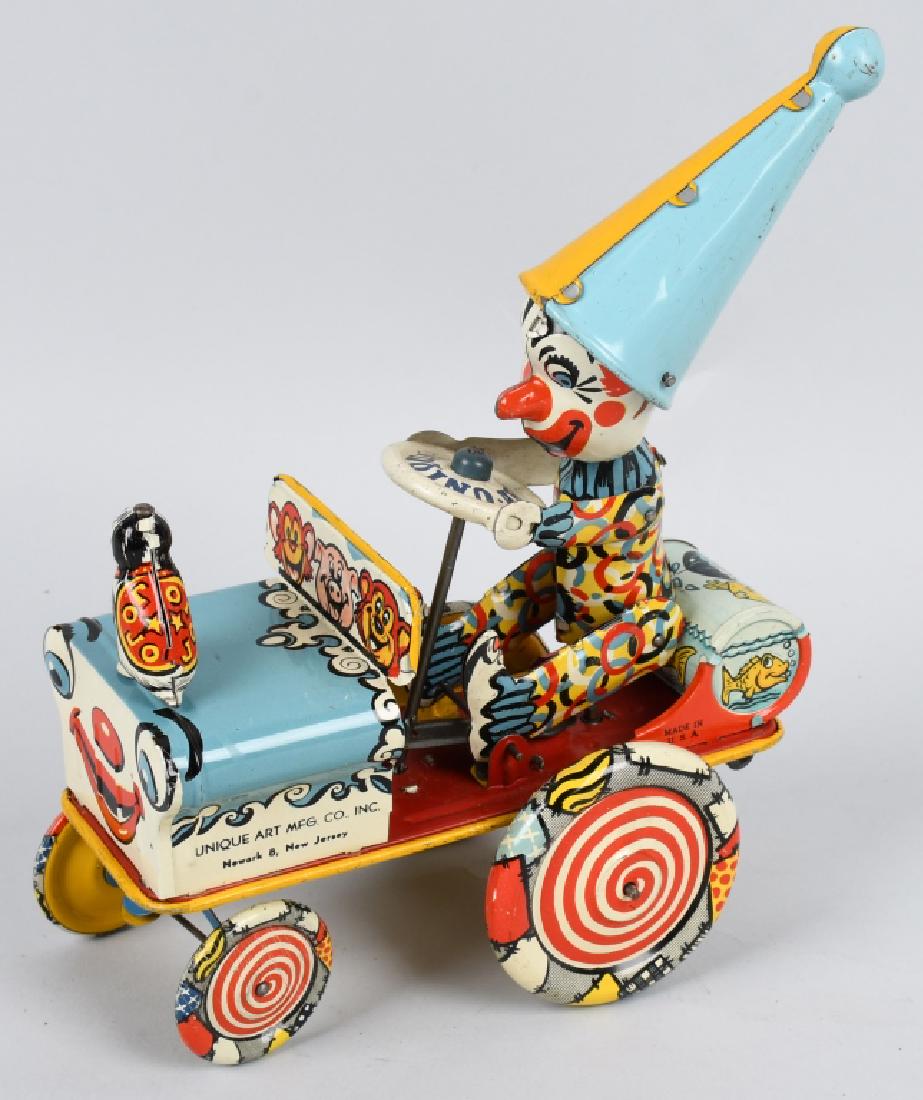 UNIQUE ART Tin Windup ARTIE the CLOWN CAR: Excellent example of this toy. Has bright colors, and factory gloss. Windup works well. Missing rubber ears due to the design of the hat. Excellent