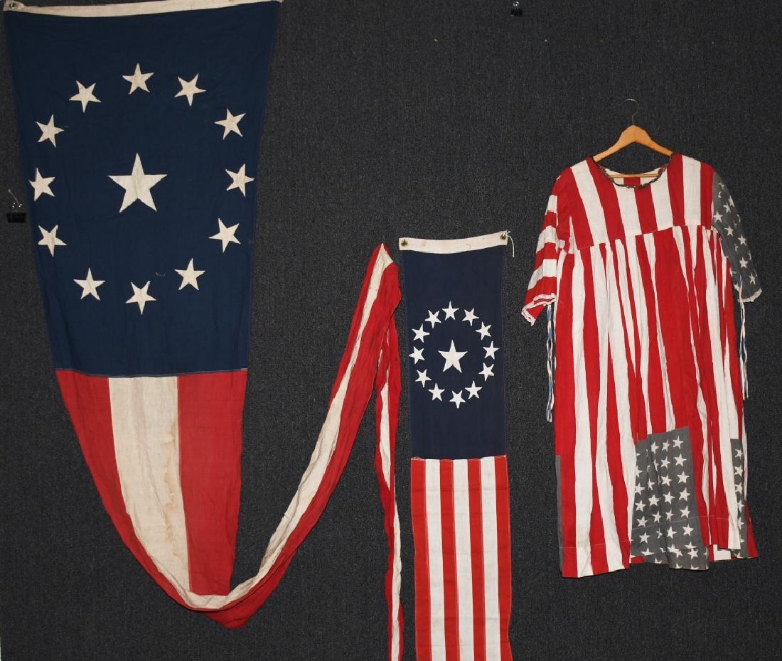 PATRIOTIC BANNER PENNANTS, AMERICAN FLAG DRESS: 2 US Flag pennants, one 14' and one 9 1/2' along with a unique patriotic dress with gold garland hand-sewn around the collar; this appears to be a home-made piece, likely for a parade or patriotic eve