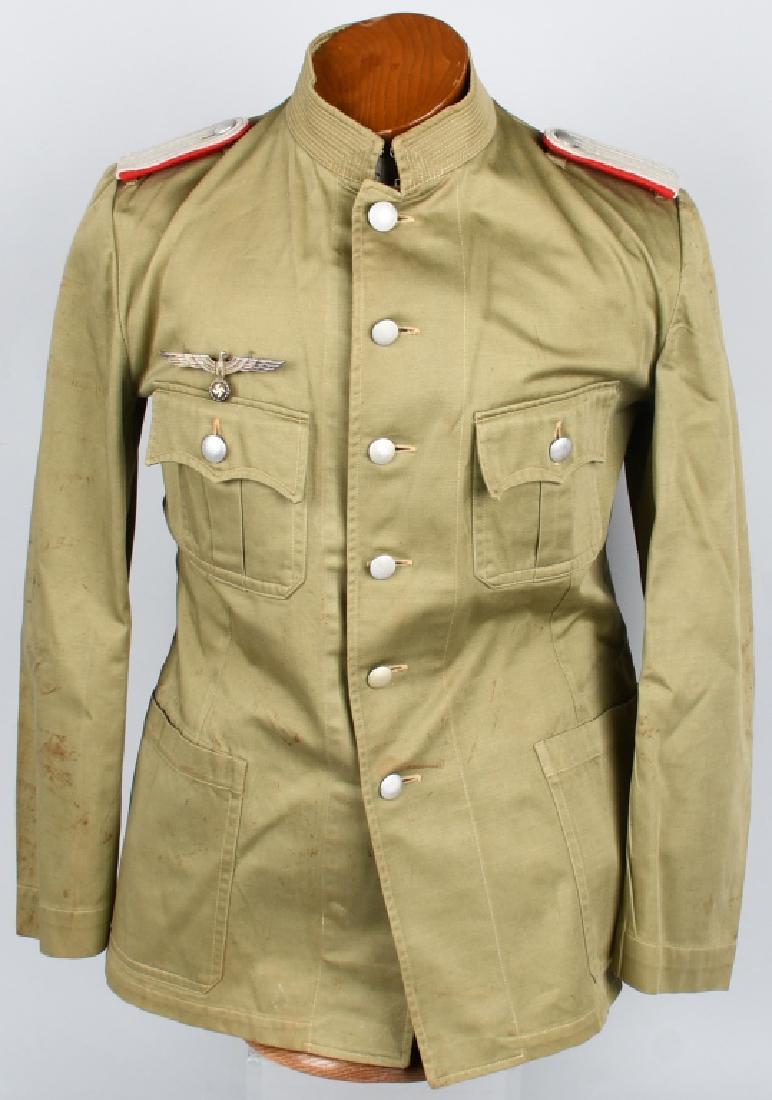 WWII NAZI GERMAN OFFICERS TROPICAL TUNIC: Officers Tropical tunic. Made out of green cotton. Has metal breast eagle and original cloth artillery shoulder boards. Is a private purchase 1942 pattern tunic. Excellent-Near Mint