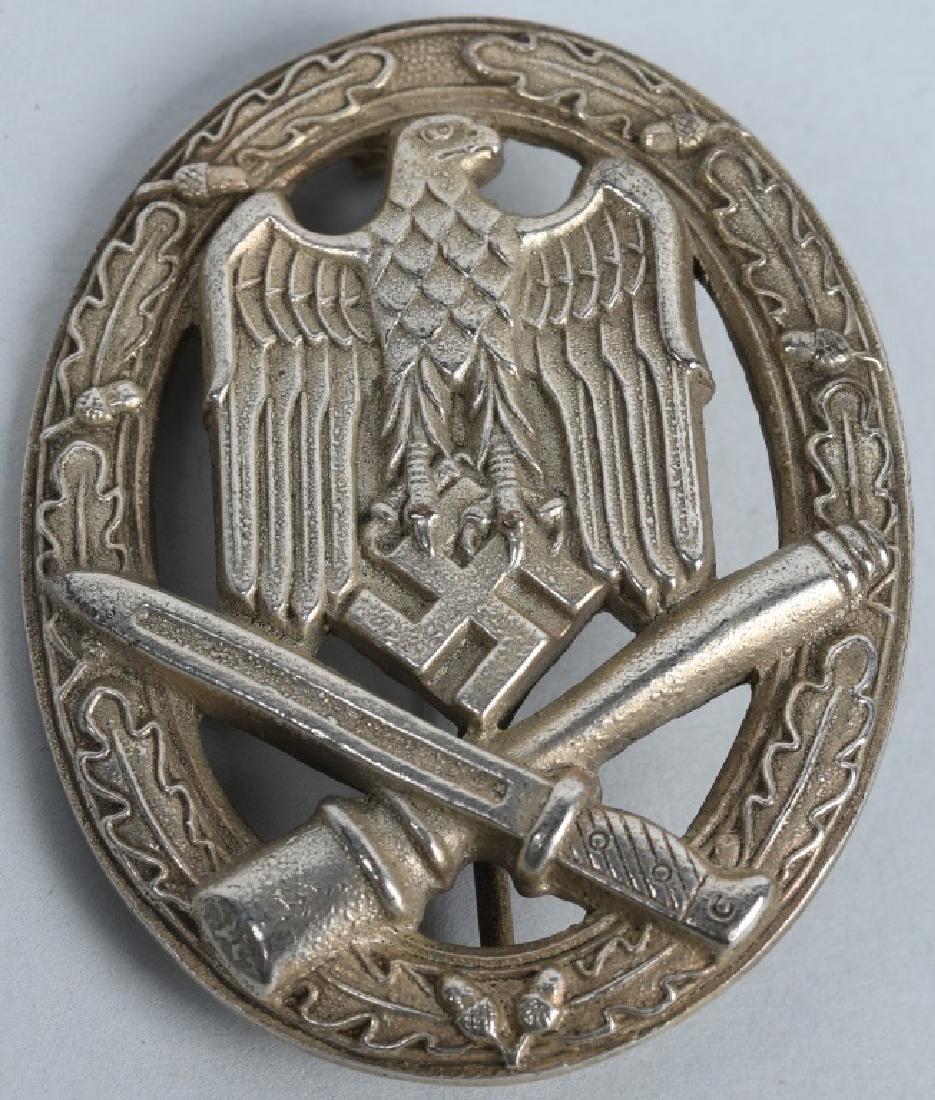 WWII NAZI GERMAN ARMY ASSAULT BADGE: The badge features a national eagle with down sweep wings atop of a crossed grenade and bayonet within an oak leaf wreath. The reserve is markers marked GB 42. Excellent