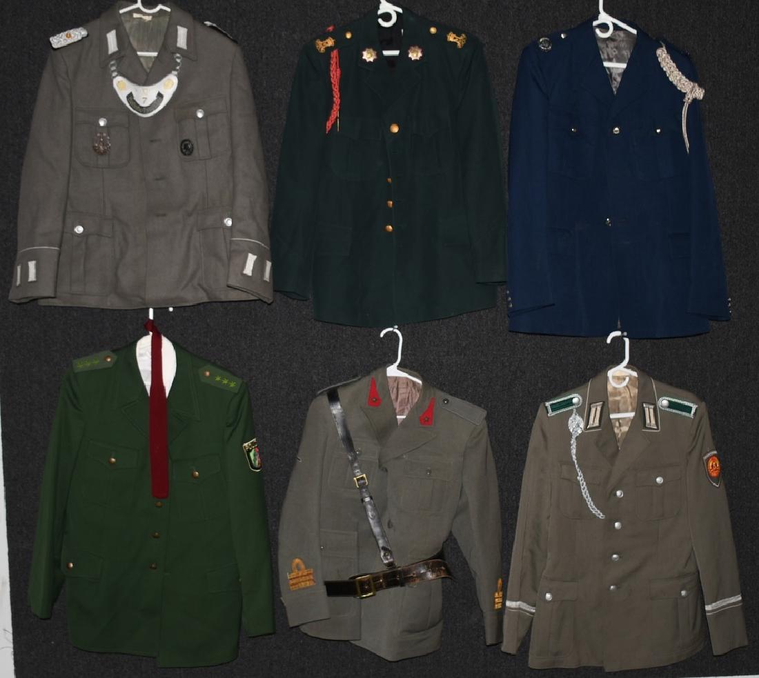 LOT OF 7 DUTCH, FRENCH, GERMAN UNIFORMS, HATS: Soviet Bloc, Cold War era, and European Military Uniforms. Some include matching hats. East German Army with Marksmanship lanyard, French Army with "UBIQUE" Pins on lapels, German Polizei, German unif