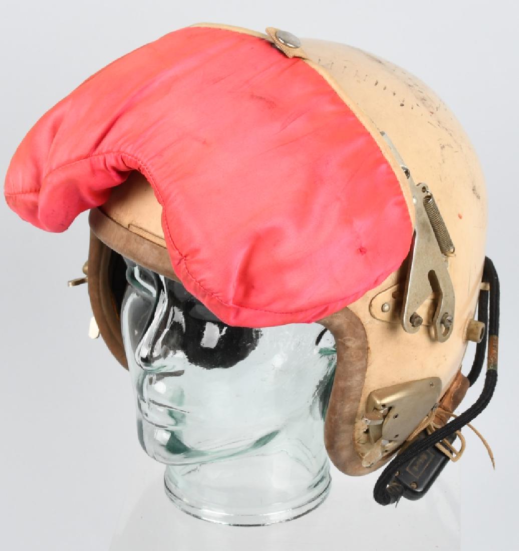 1950S US P4 JET FIGHER PILOT HELMET WITH VISOR: Early jet age aviation helmet the P4 first model was equipped with integrated communication equipment, an adjustable head net, and a mobile eye shield. This helmet is marked with the "US AIR FORCE" in