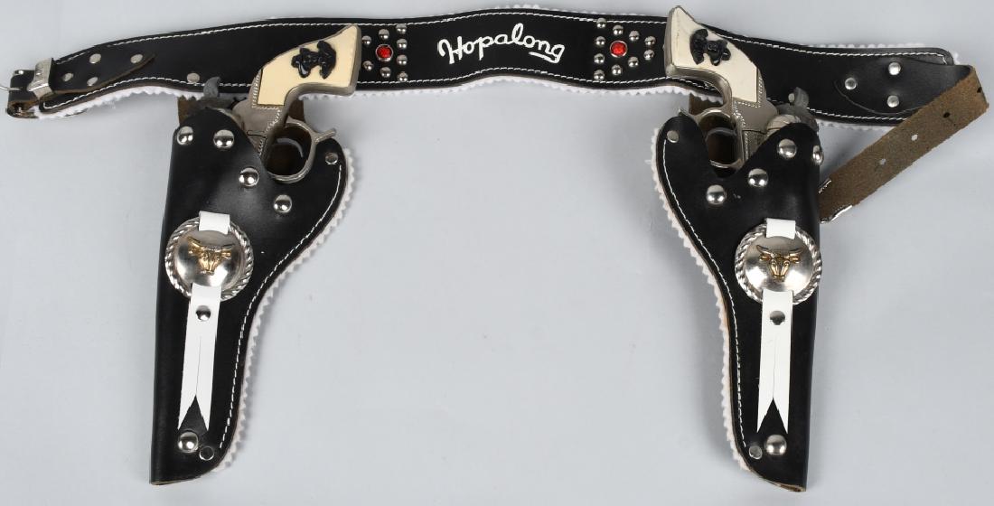 HOPALONG CASSIDY 2 GUN HOLSTER SET: Pair of Hopalong Cassidy Cap Guns and Matching Holster. Guns all original and work. Set is super clean. Guns measure 9 1/2" Excellent