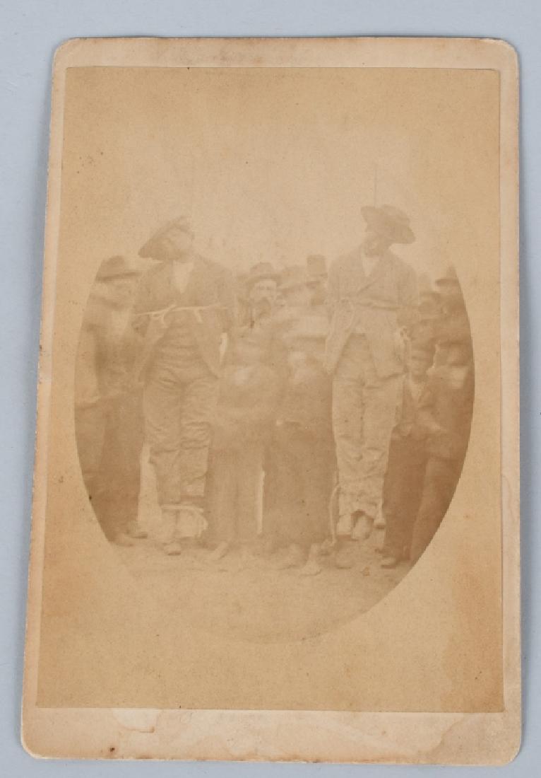 LYNCHING OF 2 BLACK MEN CABINET CARD: Original original Cabinet Card showing 2 Black Men being Lynched with crown in the background. Card is faded. Has nature scene on backside of the card. Very Good