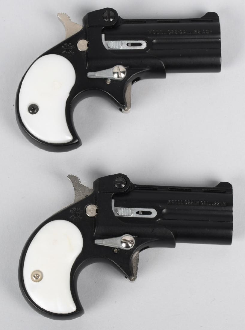 PAIR OF COBRA C22LR DERRINGERS IN 22LR DOUBLE: SN 070344 & 042614. 2.4" double-barrel single-action pistols in .22 Long Rifle. Both have faux pearl grips, matte black powder coat, and fixed sights. Both in near mint condition - action and bore nea