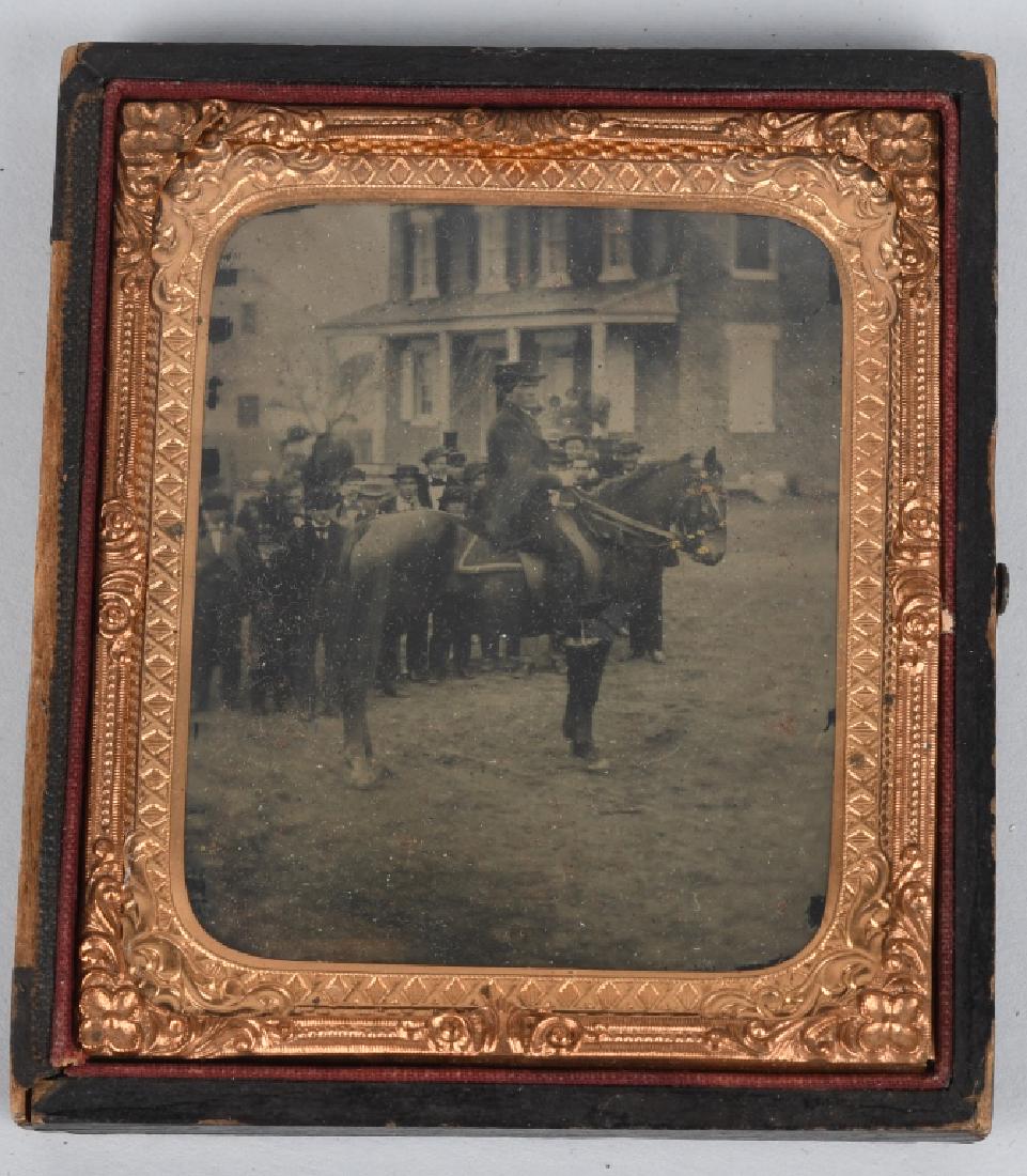 AMBROTYPE 1/6 PLATE OUTDOOR MAN on HORSE: Nice clear outdoor image of a man on horse back in front of a crowd of men. The man sits high in the saddle and has a serious and unrelenting look on his face. The saddle blanket may be military. Cont