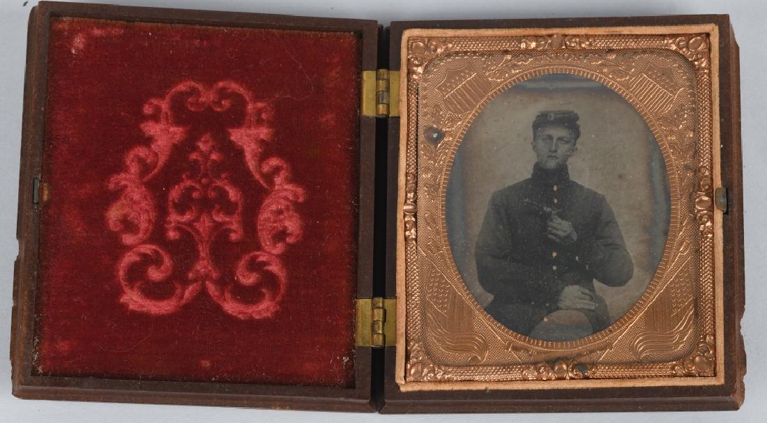 CIVIL WAR 1/6 RUBY AMBROTYPE ID'd ARMED: Very nice ruby ambrotype of a young soldier holding a pinfire pocket revolver. Has identification written inside case , and the last name looks like Morrill. The themo plastic case has nice design and