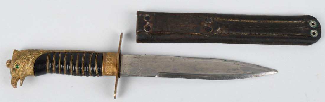 WWII ITALIAN YOUTH DAGGER IN LEATHER SCABBARD: Gioventu Italiana del Littorio or GIL organization was the Fascist Youth organization. This example with a cast brass eagle head with green glass eyes. The scabbard is made of hard leather with a belt