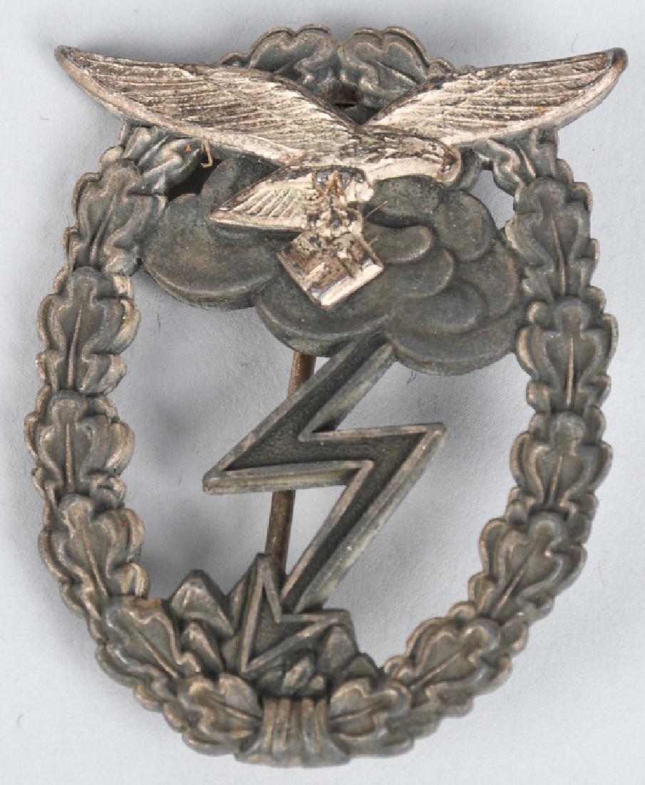 WWII NAZI GERMAN LUFTWAFFE GROUND COMBAT BADGE: Nice quality two piece solid backed die struck alloy construction badge with bright silver and burnished grey finishes is in the form of a silver washed vertically oval oak-leaf wreath with a separate