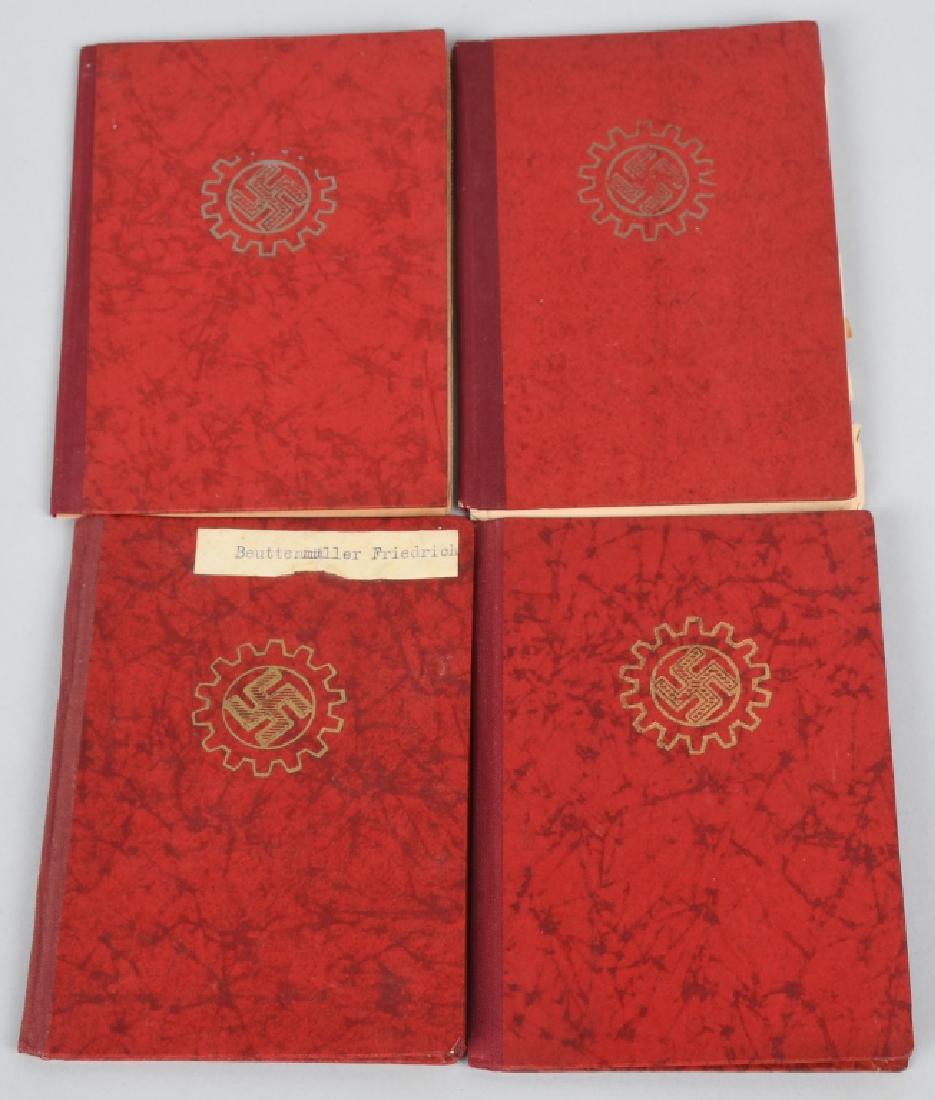 WWII NAZI GERMAN DAF MEMBERSHIP BOOK LOT OF 4: Lot of 4 sixteen page membership books that have a red patterned cover to the front of which is stamped in gold the DAF emblem of a mobile swastika within a fourteen-toothed cog. To the inside page af