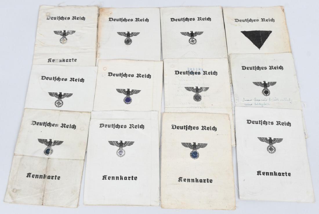 WWII NAZI GERMAN CIVIL IDENTIFICATION CARD LOT 12: Lot of 12 light grey oilcloth half-fold, "Kennkarte" (Identity-card) whose closed cover measures 10.5cm x 14cm. Its cover features a black spread-winged eagle with a wreathed mobile swastika in its ta