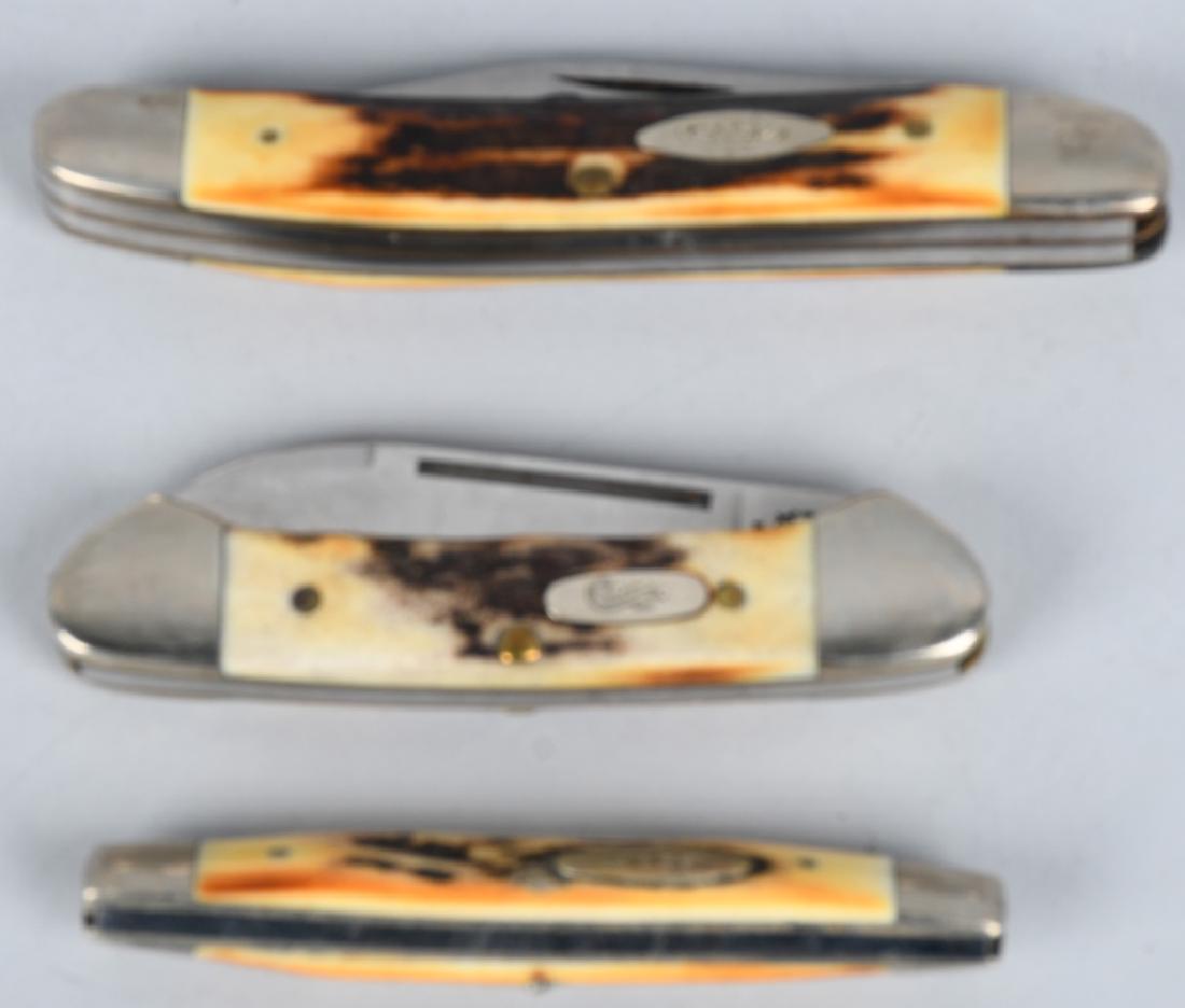 3 VINTAGE STAG HANDLE CASE FOLDING KNIVES: 3 Case knives. 3-blade with blue inlay engraved knife, 52087 -- 2.5" and 2" blade. 2-blade with same blue engraving on blade, 5233 with 1.75" blade and 1.4" blade. Case XX 62132 2-blade knife with jig