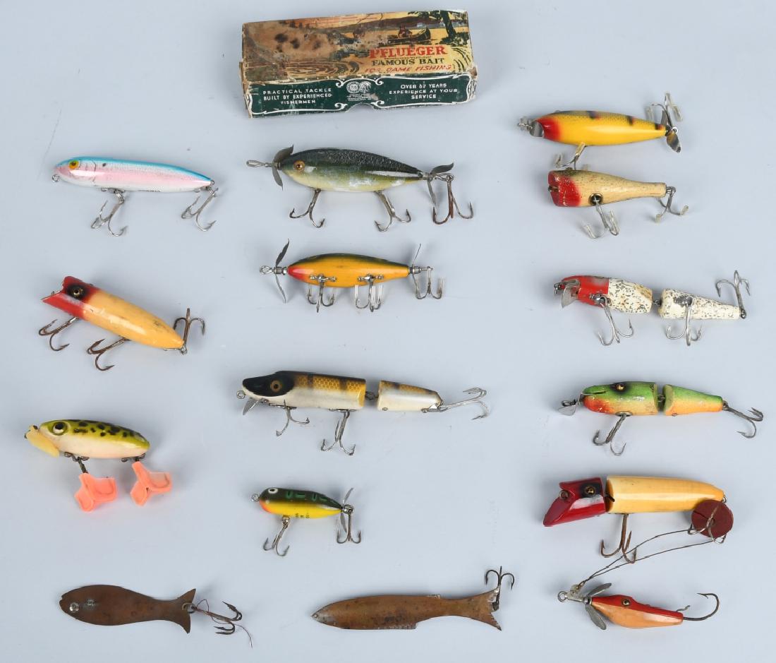 15 VINTAGE FISHING LURES: Lot includes 15 vintage fishing lures. Mostly wood and metal construction, jointed, one in the original box, ranging in size from approximately 2" to 7." Includes Heddon , Pflueger, and more. Excellen