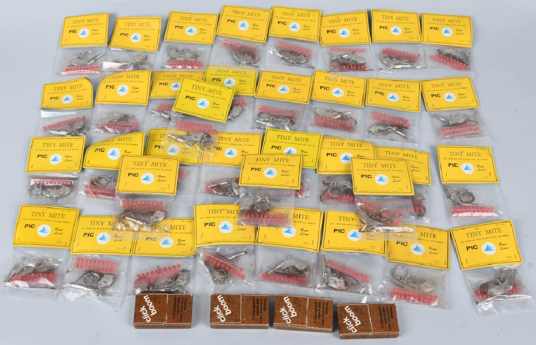 36- NEW OLD STOCK TINY MITE CAP GUN KEYCHAINS: Lot of 36 still sealed in package with caps. Comes with some extra boxes of caps/ Guns measure 2 1/4" Mint