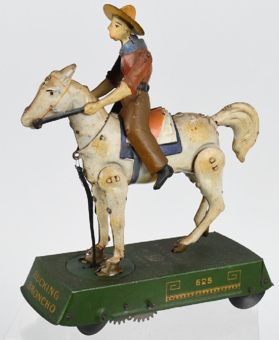 LEHMANN GERMANY tin windup BUCKING BRONCO: Complete and all original toy in working condition. White horse version. Has scratching on base. 7 1/2" by 7", Very Good