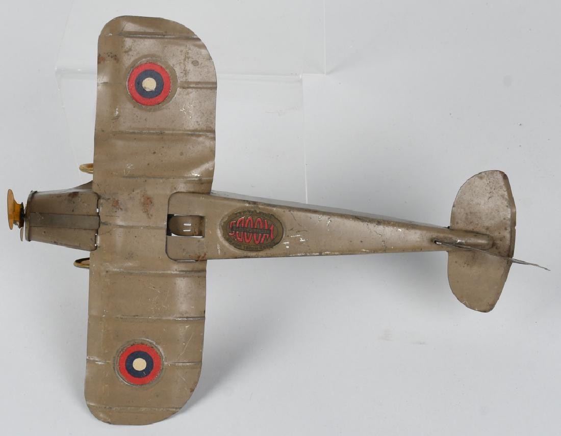 GIRARD WOODS tin windup AIRPLANE: Tin windup airplane made by Girard Woods in the 1920's-30's. Nice original paint, and has some bending to the wings. Windup works well. Missing pilot. 10" WS by 12 1/2". Very Good