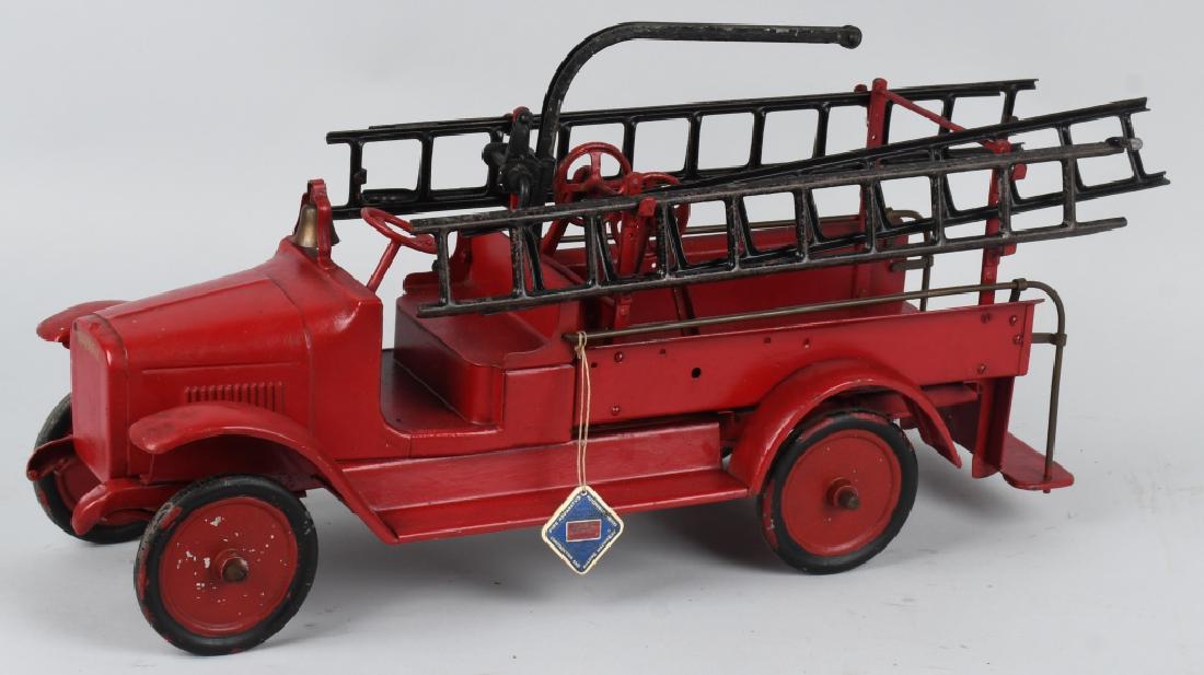 BUDDY L 1920's HOOK and LADDER FIRE TRUCK: Solid 1920's Buddy L Hook & Ladder truck that has been over painted. The hose reel needs to be remounted. Includes a replacement Buddy L string tag. Displays well. 26", Good