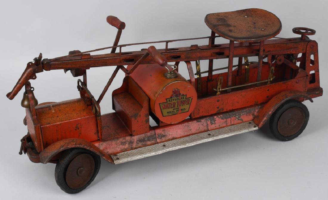 KEYSTONE 1920's PACKARD WATER TOWER FIRE TRUCK: 1920's Keystone ride on Packard Water Tower truck. Original paint and decals. Complete except for side ladders. Has paint fading and general wear. Original tires are distressed. May clean to a higher 