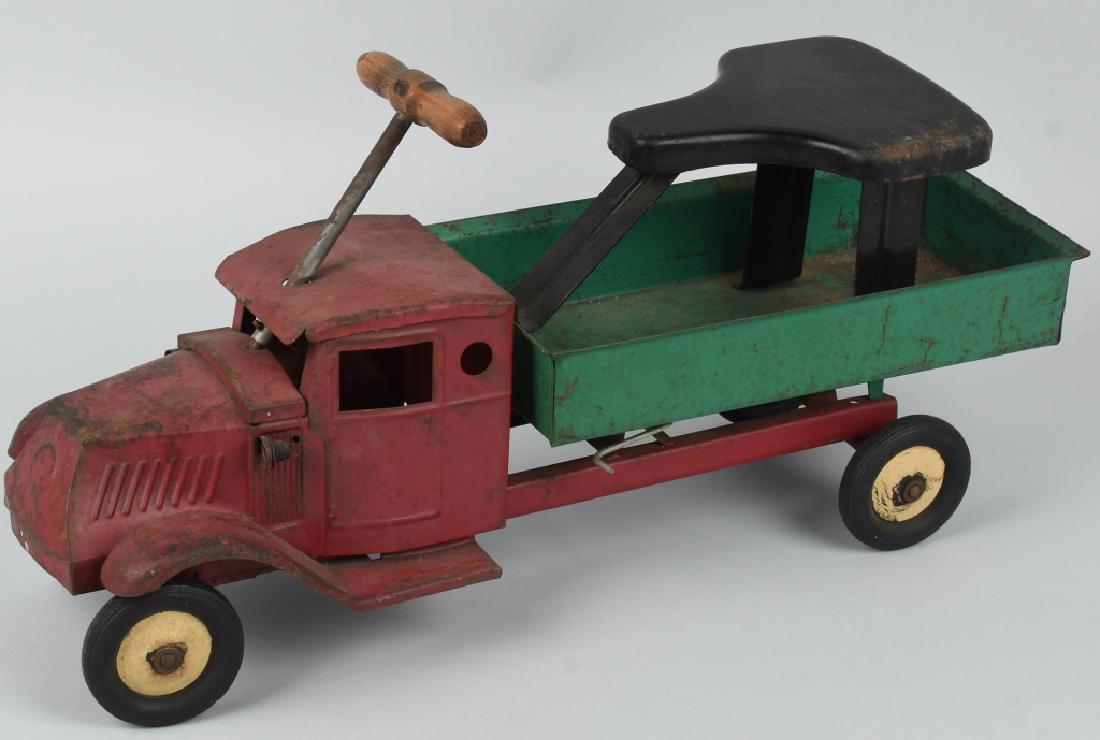 STEELCRAFT 1920's-30's SIT-N-RIDE MACK DUMP TRUCK: Very nice all original Steelcraft mack dump truck with electric lights. Removable seat clips into rear window and rests on bed. Complete and original and may clean to a higher grade. Rear axle is loos